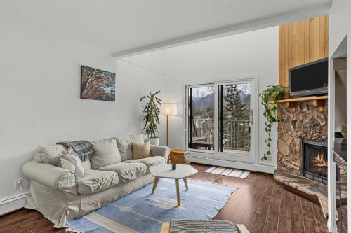 214-200 Three Sisters Drive, Canmore, AB - Indoor Photo Showing Living Room With Fireplace