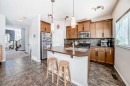 296 Sunset Point, Cochrane, AB  - Indoor Photo Showing Kitchen With Double Sink 
