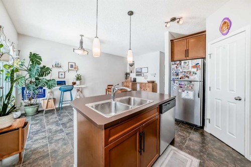 296 Sunset Point, Cochrane, AB - Indoor Photo Showing Kitchen With Double Sink