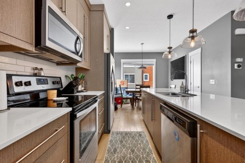 43-111 Rainbow Falls, Chestermere, AB - Indoor Photo Showing Kitchen With Stainless Steel Kitchen With Double Sink With Upgraded Kitchen