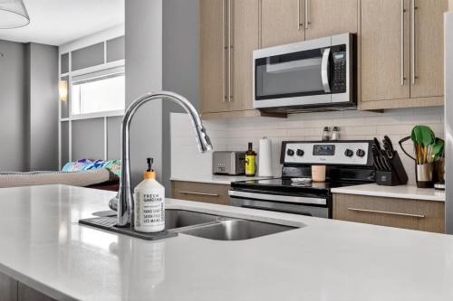 43-111 Rainbow Falls, Chestermere, AB - Indoor Photo Showing Kitchen With Stainless Steel Kitchen With Double Sink With Upgraded Kitchen