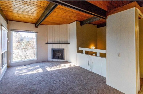 92 Queen Isabella Close Se, Calgary, AB - Indoor With Fireplace