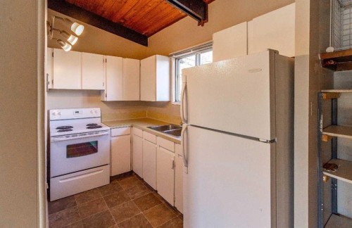92 Queen Isabella Close Se, Calgary, AB - Indoor Photo Showing Kitchen With Double Sink