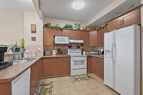 40 Cimarron Grove Drive, Okotoks, AB - Indoor Photo Showing Kitchen With Double Sink