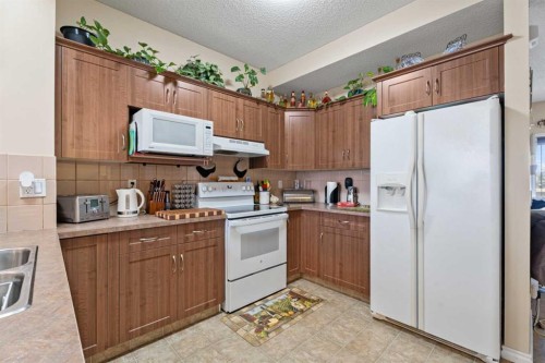 40 Cimarron Grove Drive, Okotoks, AB - Indoor Photo Showing Kitchen With Double Sink