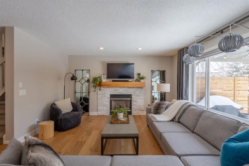 77 Weston Way Sw, Calgary, AB - Indoor Photo Showing Living Room With Fireplace