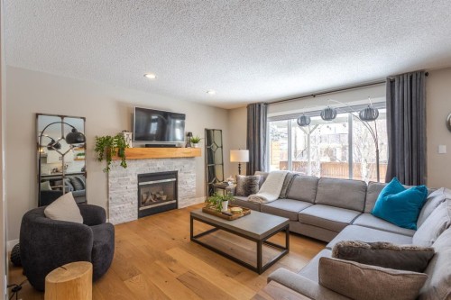 77 Weston Way Sw, Calgary, AB - Indoor Photo Showing Living Room With Fireplace