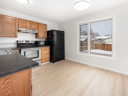 84 Queen Anne Close Se, Calgary, AB - Indoor Photo Showing Kitchen With Double Sink