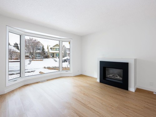 84 Queen Anne Close Se, Calgary, AB - Indoor Photo Showing Living Room With Fireplace