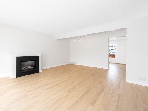 84 Queen Anne Close Se, Calgary, AB - Indoor Photo Showing Living Room With Fireplace