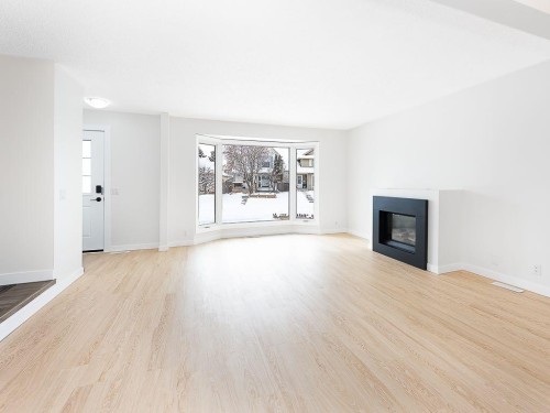 84 Queen Anne Close Se, Calgary, AB - Indoor Photo Showing Living Room With Fireplace