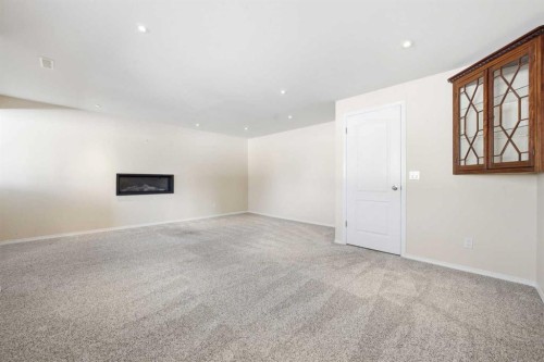59 Sunlake Close Se, Calgary, AB - Indoor Photo Showing Other Room With Fireplace
