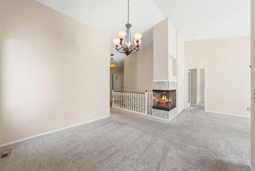 59 Sunlake Close Se, Calgary, AB - Indoor Photo Showing Other Room With Fireplace