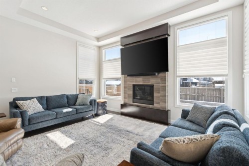 293 Boulder Creek Crescent, Langdon, AB - Indoor Photo Showing Living Room With Fireplace