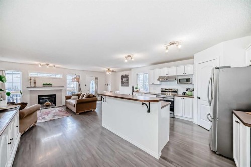 69 Canals Circle Sw, Airdrie, AB - Indoor Photo Showing Kitchen With Fireplace