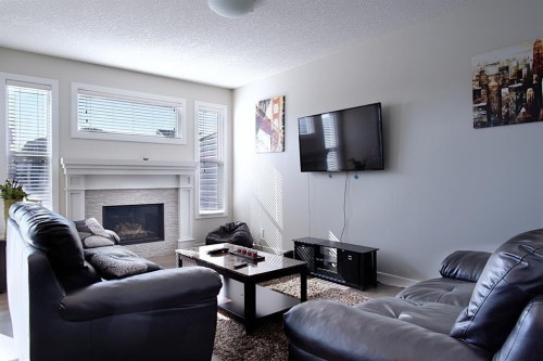 193 Redstone Common Ne, Calgary, AB - Indoor Photo Showing Living Room With Fireplace