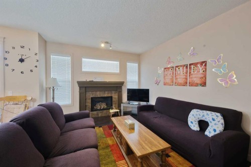 18 Redstone Manor Ne, Calgary, AB - Indoor Photo Showing Living Room With Fireplace