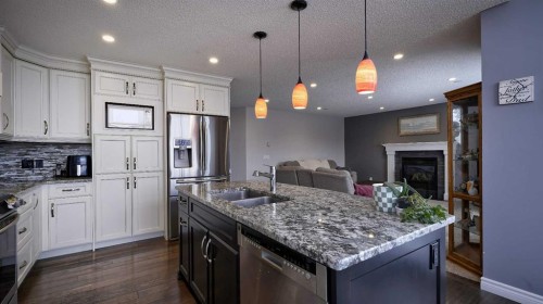 139 Coopers Close Sw, Airdrie, AB - Indoor Photo Showing Kitchen With Double Sink With Upgraded Kitchen