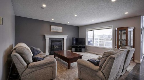 139 Coopers Close Sw, Airdrie, AB - Indoor Photo Showing Living Room With Fireplace