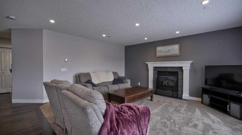 139 Coopers Close Sw, Airdrie, AB - Indoor Photo Showing Living Room With Fireplace