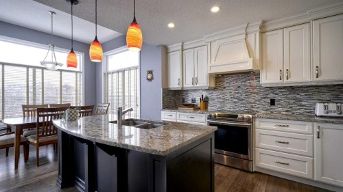 139 Coopers Close Sw, Airdrie, AB - Indoor Photo Showing Kitchen With Double Sink With Upgraded Kitchen