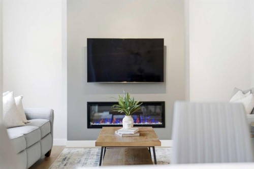 316 Precedence Hill, Cochrane, AB - Indoor Photo Showing Living Room With Fireplace