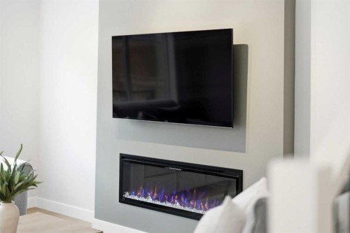 316 Precedence Hill, Cochrane, AB - Indoor Photo Showing Living Room With Fireplace