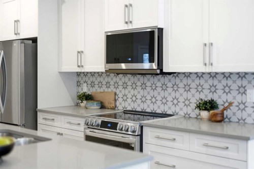 316 Precedence Hill, Cochrane, AB - Indoor Photo Showing Kitchen With Stainless Steel Kitchen With Upgraded Kitchen