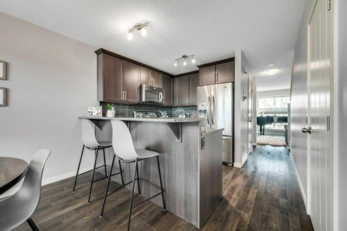 731-101 Sunset Drive, Cochrane, AB - Indoor Photo Showing Kitchen With Upgraded Kitchen