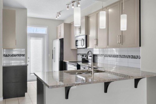 78 New Brighton Landing Se, Calgary, AB - Indoor Photo Showing Kitchen With Double Sink With Upgraded Kitchen