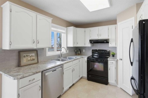 88 Sunmeadows Road Se, Calgary, AB - Indoor Photo Showing Kitchen With Double Sink