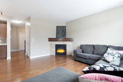 147 Morningside Mews Sw, Airdrie, AB - Indoor Photo Showing Living Room With Fireplace