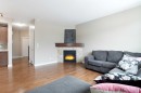 147 Morningside Mews Sw, Airdrie, AB  - Indoor Photo Showing Living Room With Fireplace 