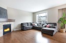 147 Morningside Mews Sw, Airdrie, AB  - Indoor Photo Showing Living Room With Fireplace 