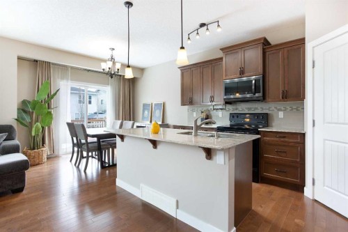 147 Morningside Mews Sw, Airdrie, AB - Indoor Photo Showing Kitchen With Upgraded Kitchen