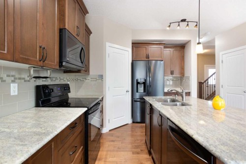 147 Morningside Mews Sw, Airdrie, AB - Indoor Photo Showing Kitchen With Double Sink