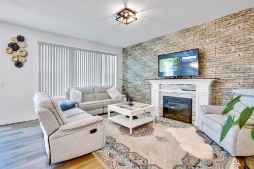 353 Walcrest View Se, Calgary, AB - Indoor Photo Showing Living Room With Fireplace