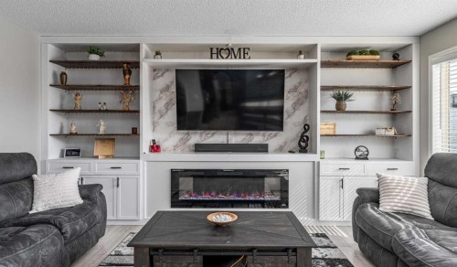 217 Bayside Place Sw, Airdrie, AB - Indoor Photo Showing Living Room With Fireplace