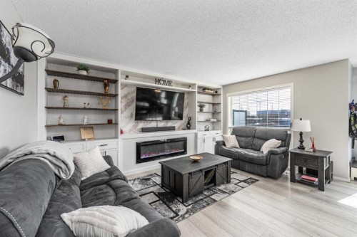 217 Bayside Place Sw, Airdrie, AB - Indoor Photo Showing Living Room With Fireplace