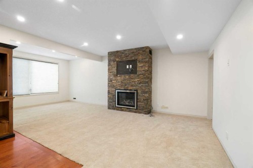44 Cougar Ridge Green, Calgary, AB - Indoor With Fireplace