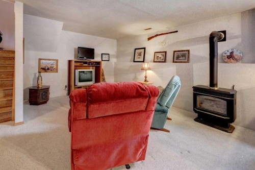 19 Everglade Drive Se, Airdrie, AB - Indoor Photo Showing Living Room With Fireplace