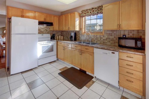 19 Everglade Drive Se, Airdrie, AB - Indoor Photo Showing Kitchen With Double Sink