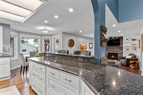 9759 Sanderling Way Nw, Calgary, AB - Indoor Photo Showing Kitchen With Fireplace