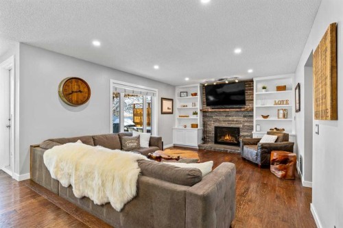 9759 Sanderling Way Nw, Calgary, AB - Indoor Photo Showing Living Room With Fireplace