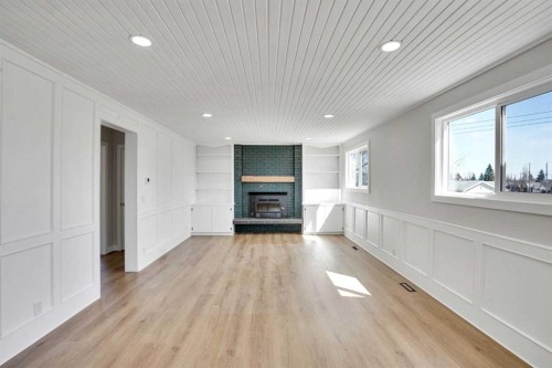 248 Madeira Place Ne, Calgary, AB - Indoor Photo Showing Other Room With Fireplace