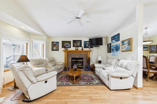 535 Cimarron Point, Okotoks, AB - Indoor Photo Showing Living Room With Fireplace