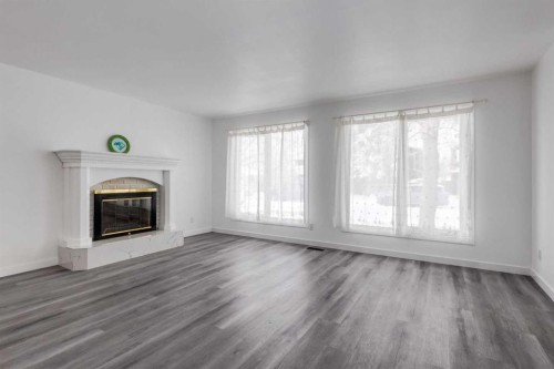 32 Midland Place Se, Calgary, AB - Indoor Photo Showing Living Room With Fireplace