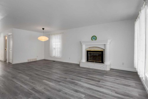32 Midland Place Se, Calgary, AB - Indoor Photo Showing Living Room With Fireplace