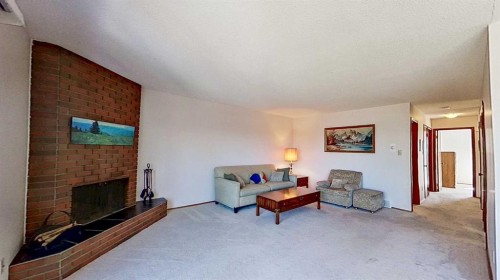 5801/5803 Dalgleish Road Nw, Calgary, AB - Indoor Photo Showing Living Room With Fireplace