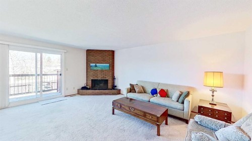 5801/5803 Dalgleish Road Nw, Calgary, AB - Indoor Photo Showing Living Room With Fireplace